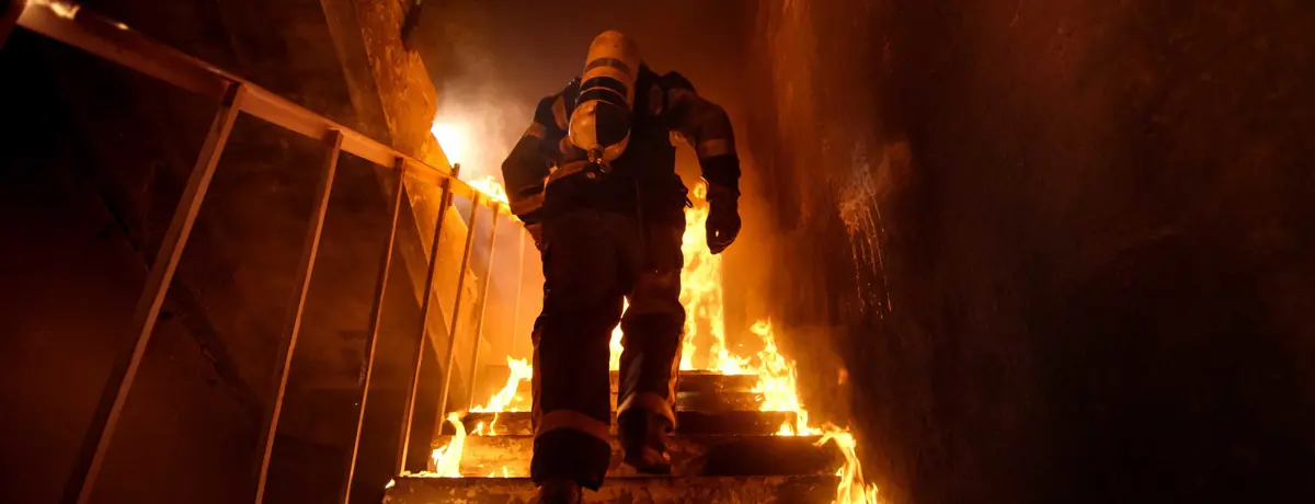 Headerbeeld brandpreventie - brandweerman die een trap oploopt
